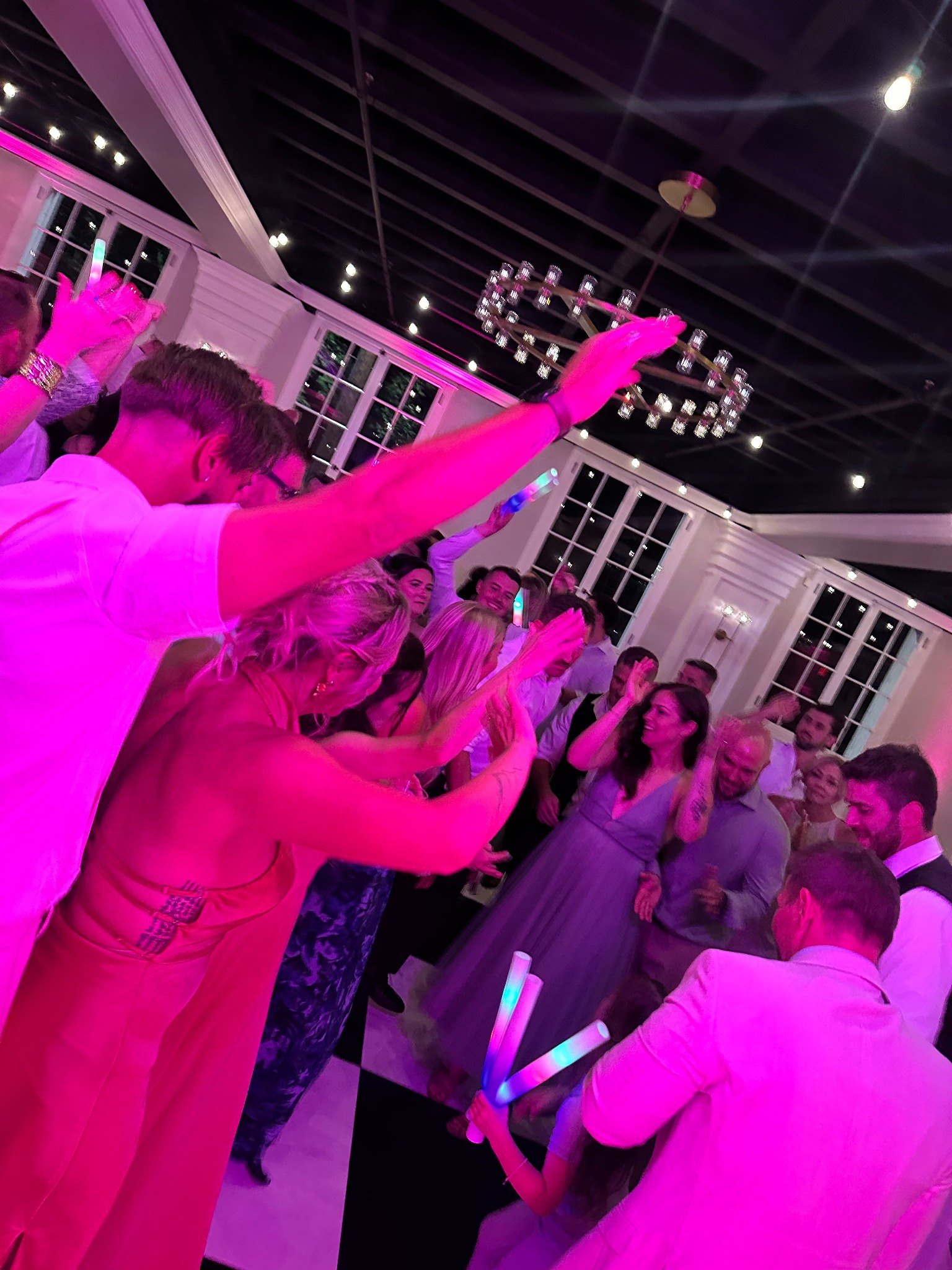 Wedding guests dancing on a packed dance floor